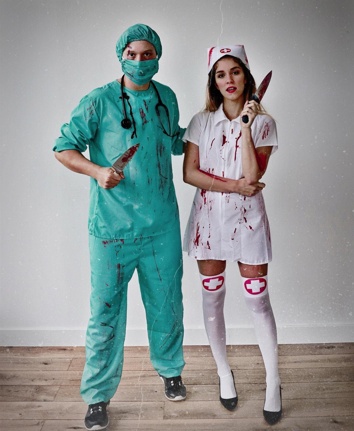 Man in teal scrubs and woman in white nurse dress holding bloody knives.