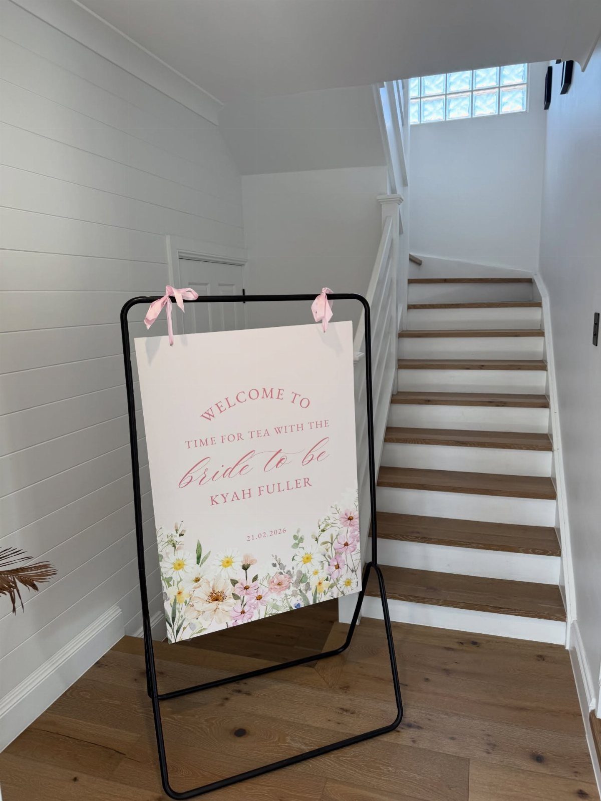 Welcome sign on a black easel for a tea party bridal shower.