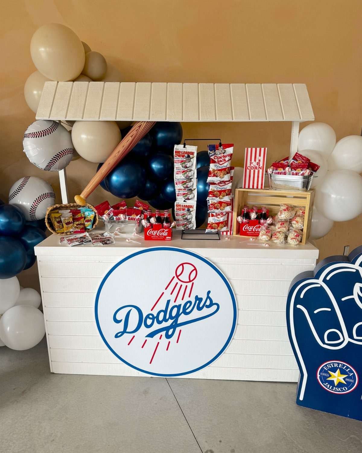 Baseball-themed snack bar styled as a concession stand with Dodgers logo and balloons.
