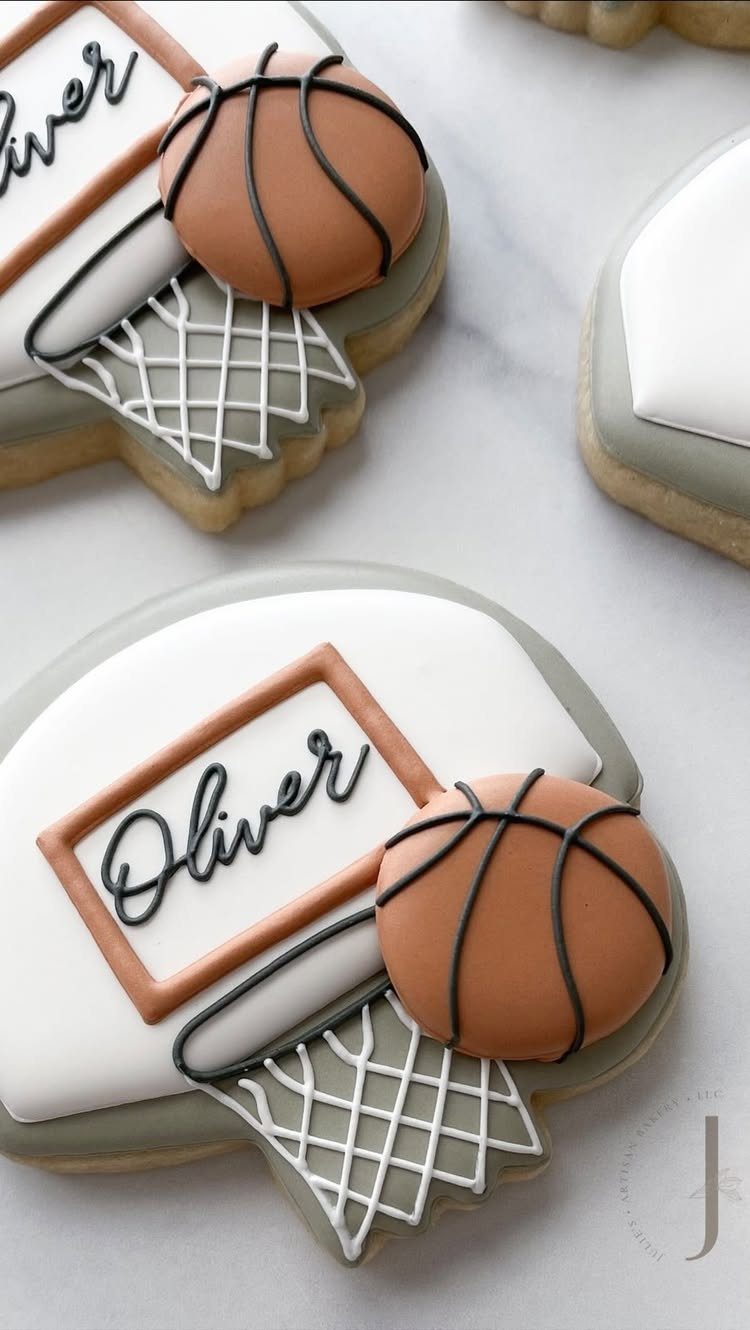 Basketball themed sugar cookies with orange balls, white nets, and personalized names.