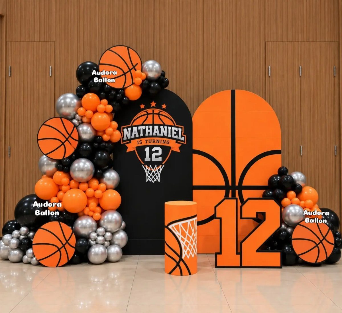 Basketball themed party backdrop with orange and black balloons and a large number 12