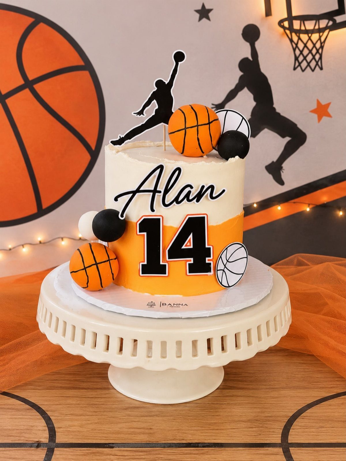 Basketball themed cake with orange accents, number 14, and player silhouette topper.