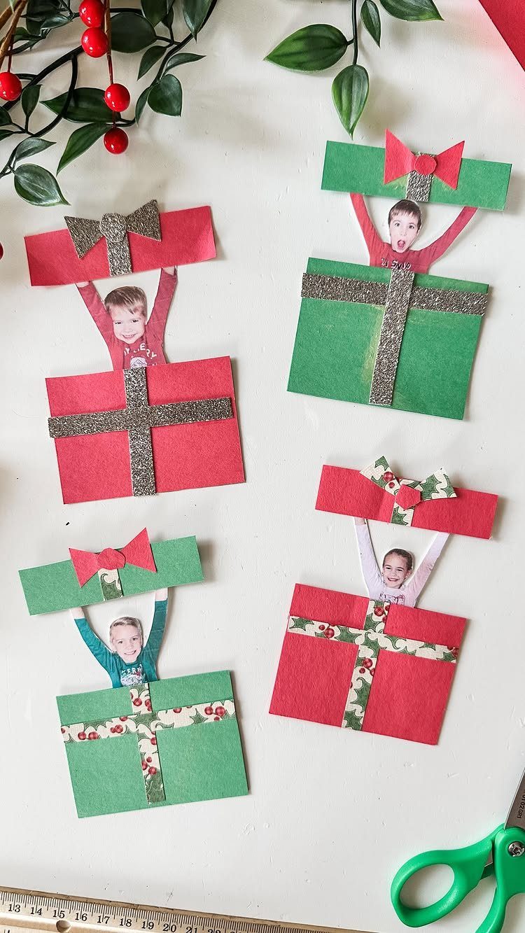 Handmade Christmas cards with children's photos popping out of red and green gift boxes.