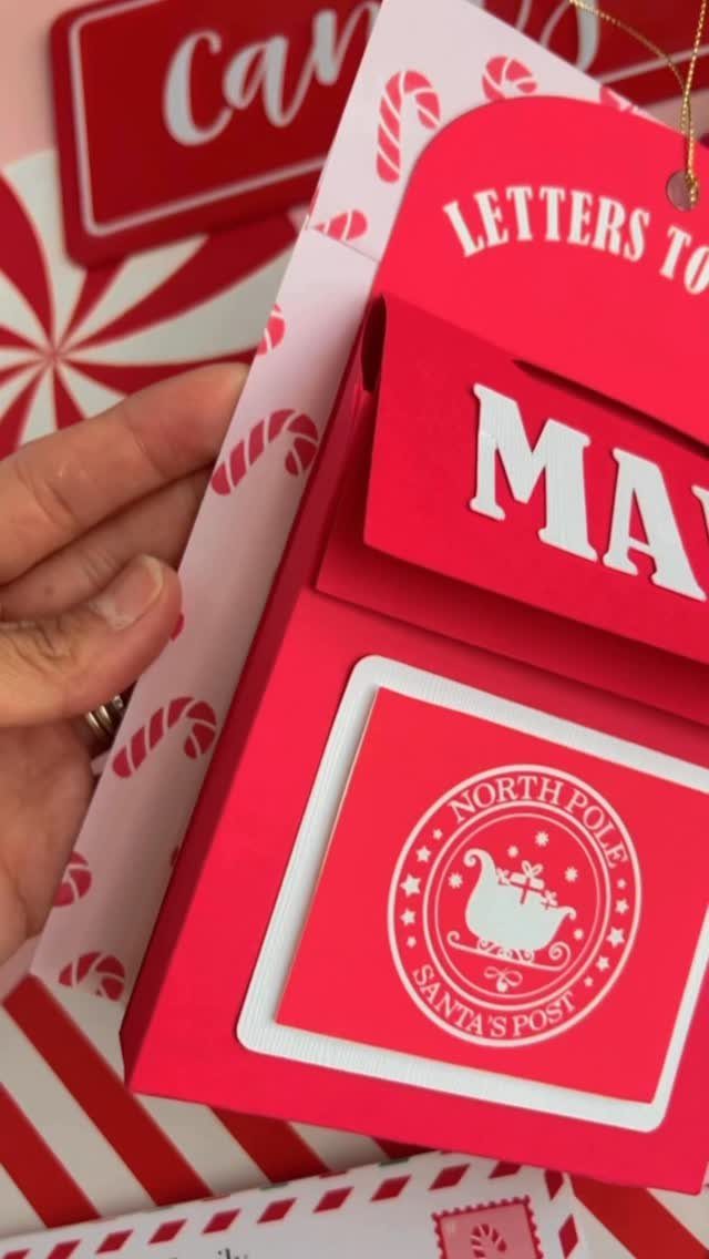 Red Christmas mail organizer for letters to Santa with candy cane patterns.
