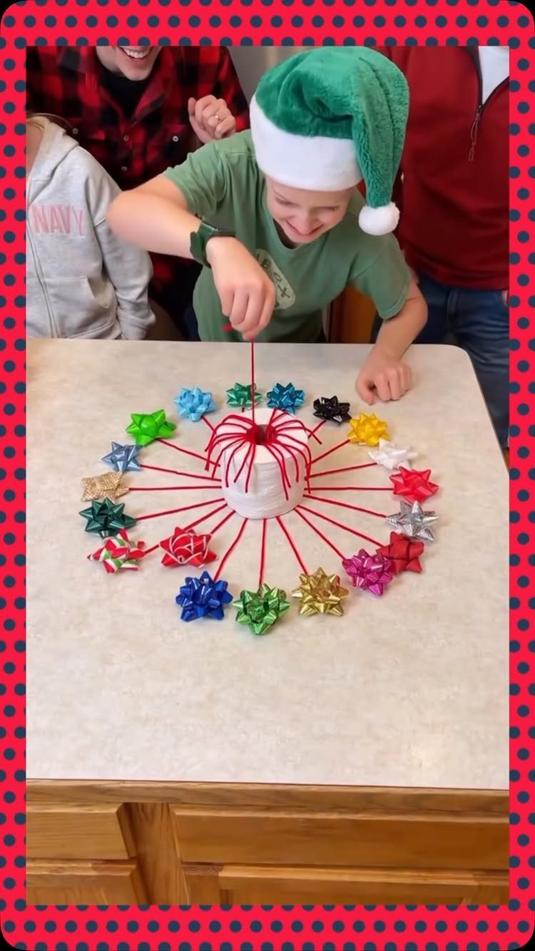 Child in elf hat playing a string-pulling game with colorful bows at Christmas.