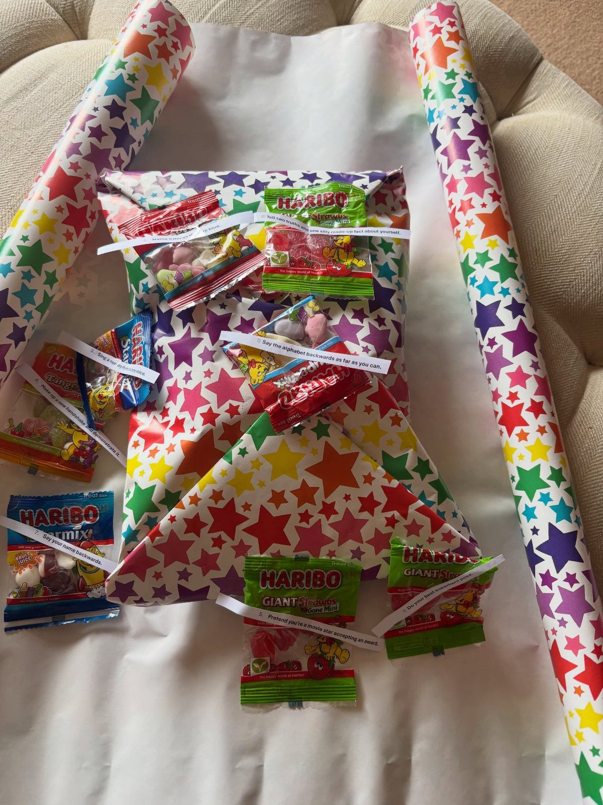Multi-layered wrapped gift with candy attached to each layer for Pass the Parcel