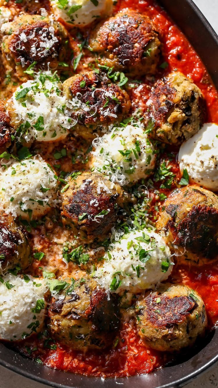 Eggplant parmesan meatballs and mozzarella balls in red sauce with parmesan and parsley.