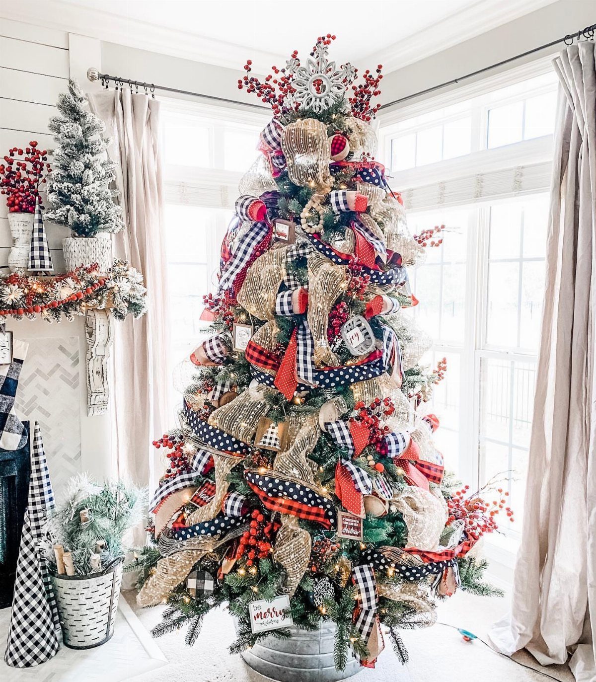 Christmas tree decorated with red and black buffalo plaid ribbons and burlap bows.