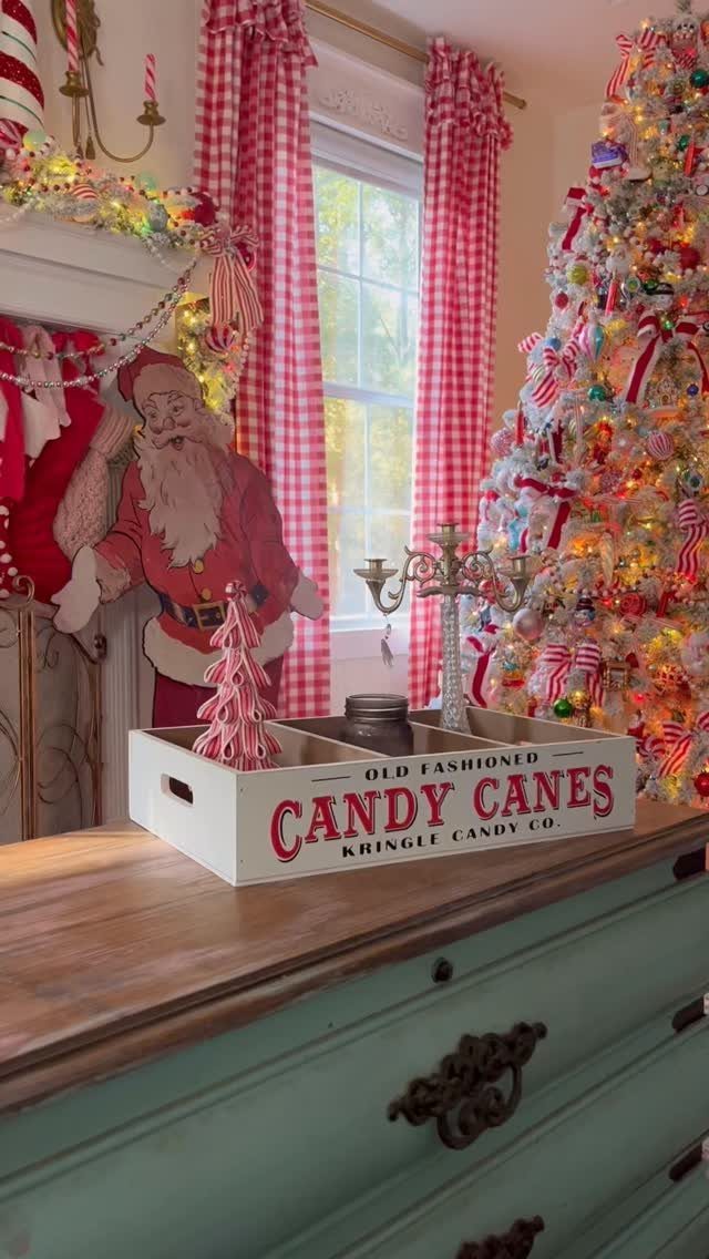 Candy cane themed Christmas decorations with a decorated tree and red gingham curtains.