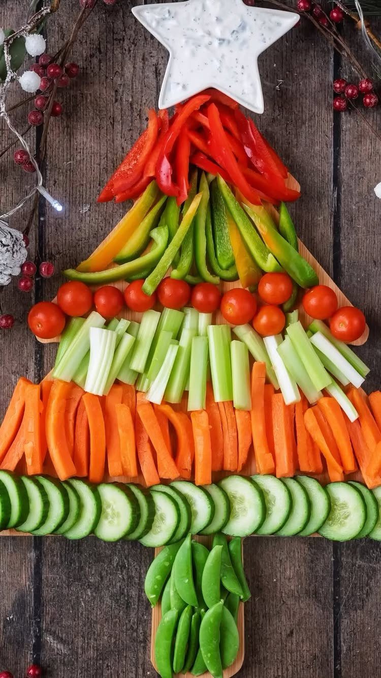 Vegetable platter arranged as a Christmas tree with a star-shaped dip bowl on top.