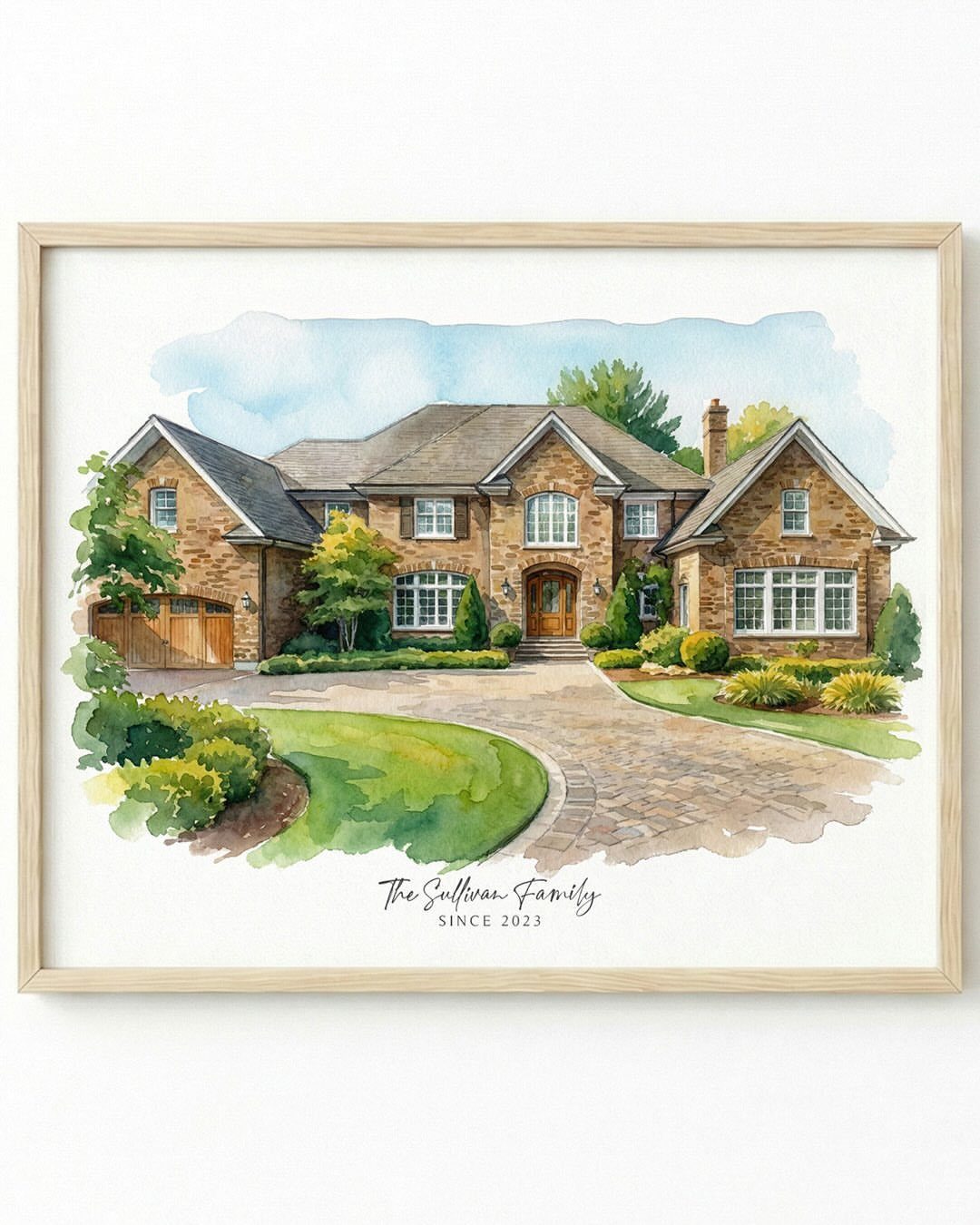 Watercolor portrait of a brick house in a light wood frame with family text.