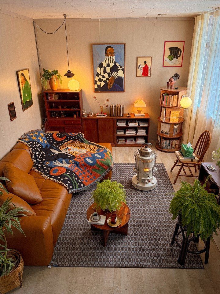 Brown leather sofa with a colorful patterned throw blanket in a cozy living room.
