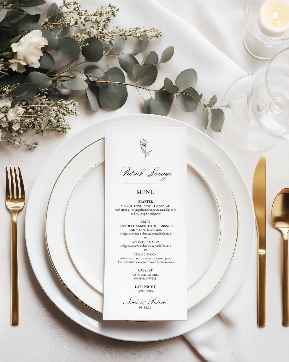 White dinner plate with gold rim and a printed menu card on tablecloth