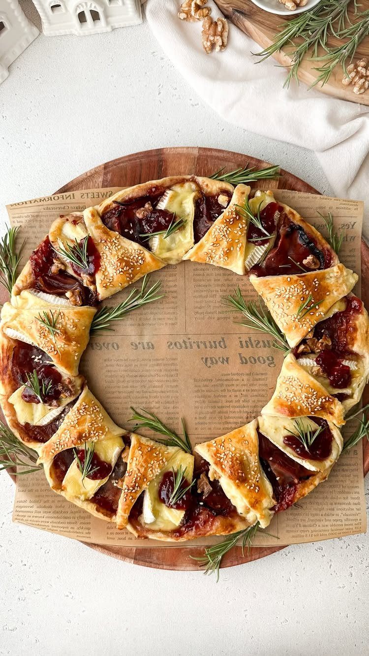 Savory puff pastry wreath with brie and jam on a wooden platter