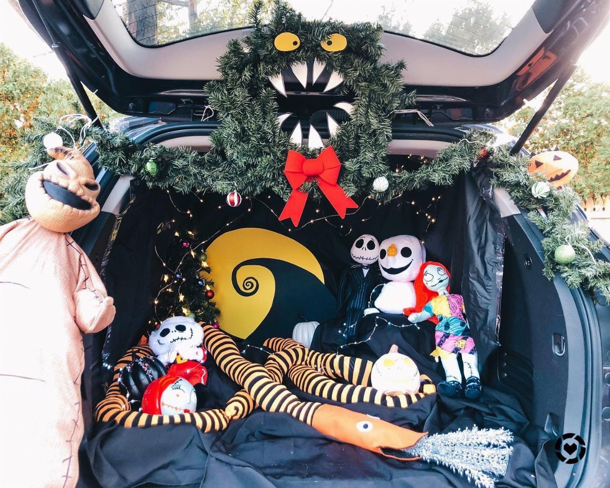 Car trunk decorated with Nightmare Before Christmas characters and a spiral hill backdrop.