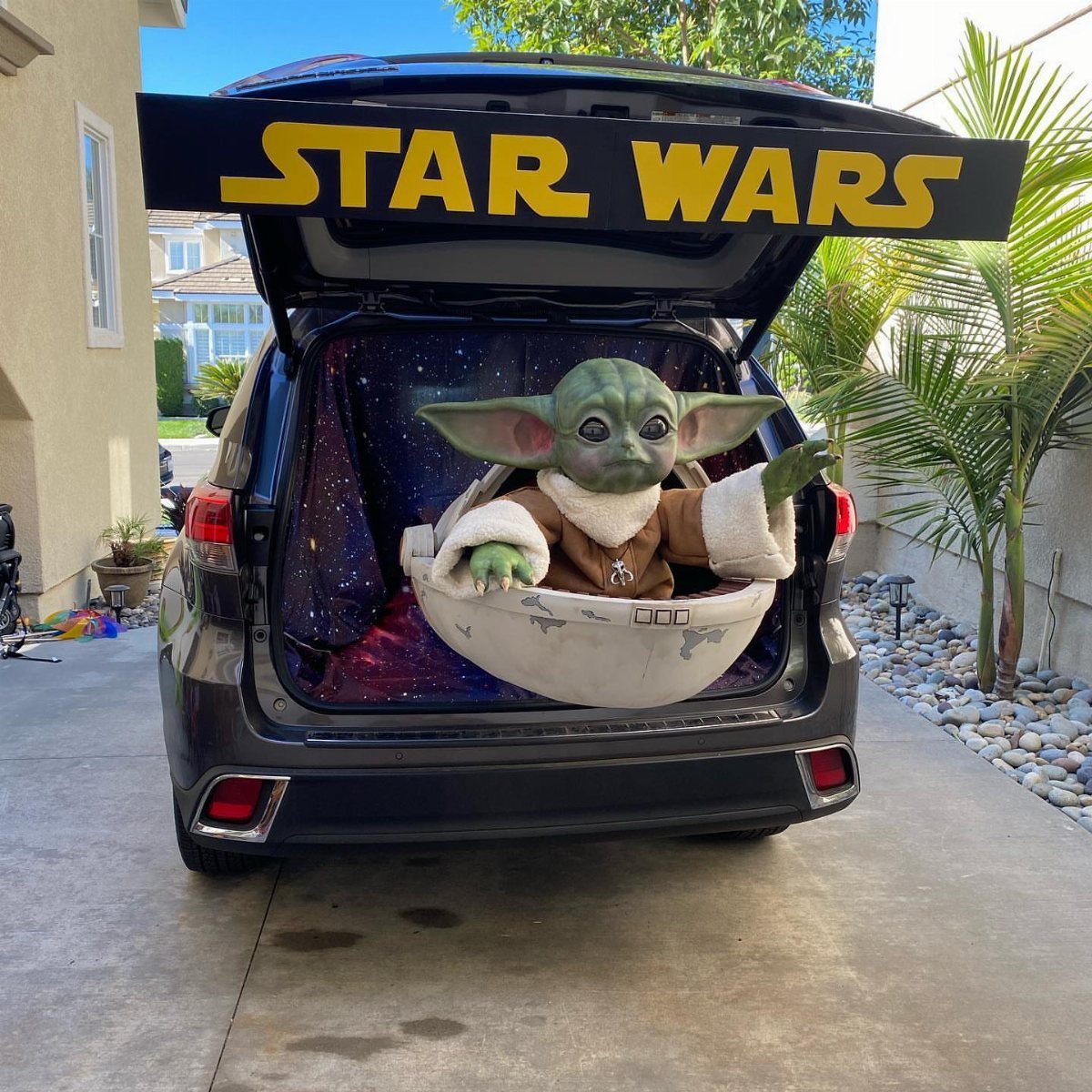 Star Wars themed car trunk featuring Grogu in a pod against space background