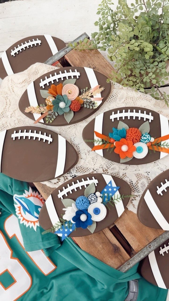 Football-shaped trays decorated with colorful felt flowers on a white lace tablecloth.