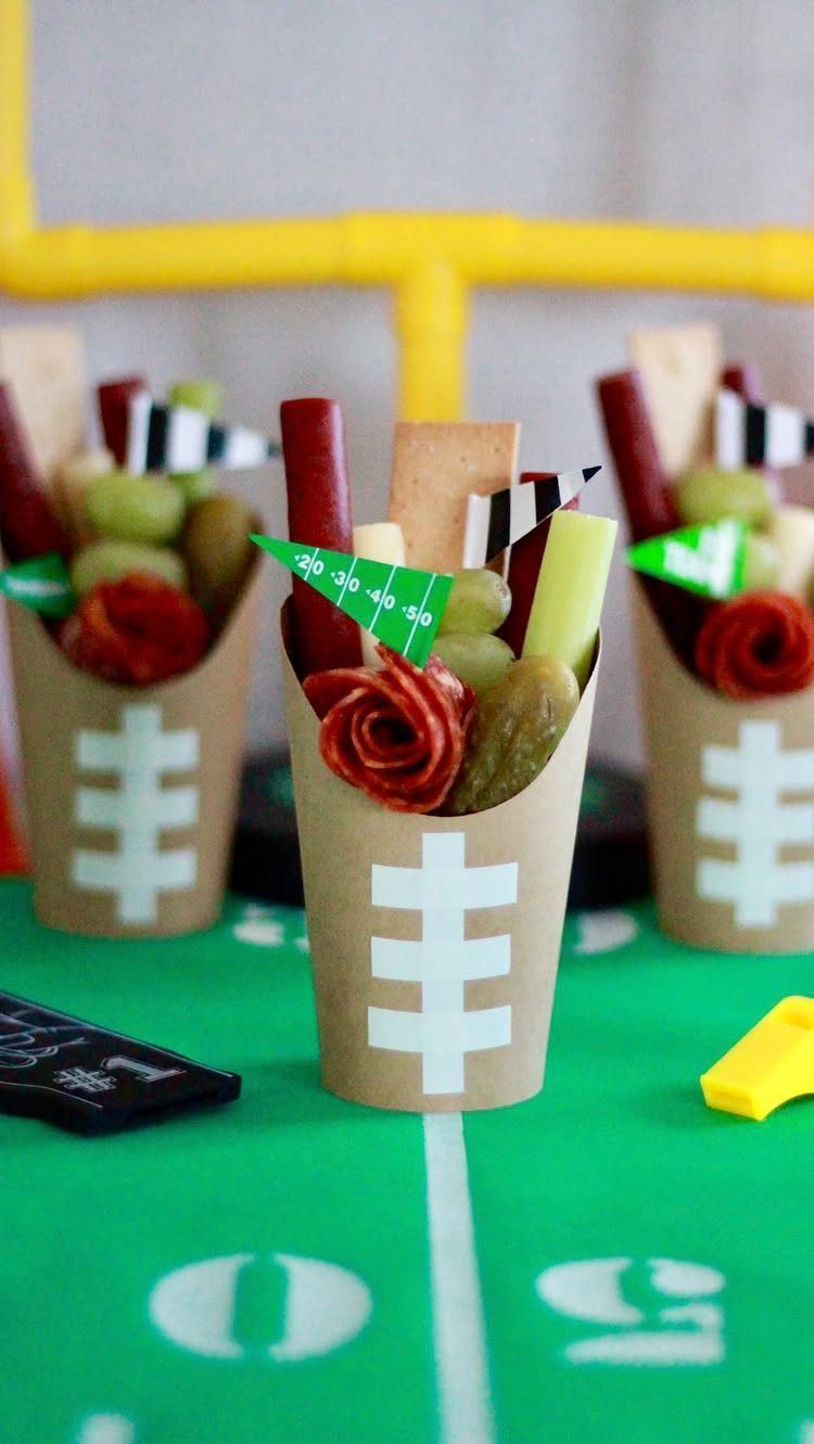 Snack cones decorated as football fields on a green football field tablecloth