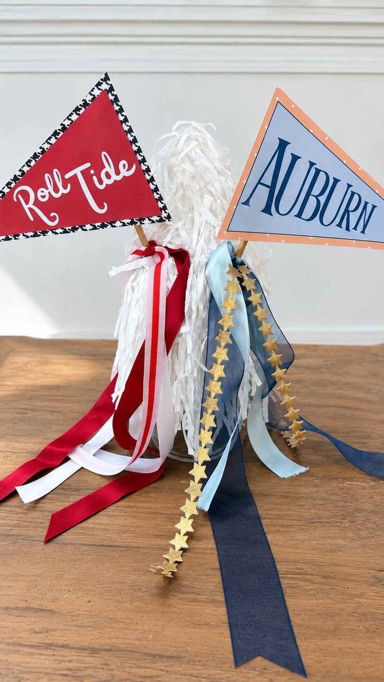 Football pennants for Roll Tide and Auburn with ribbons in a white pom-pom