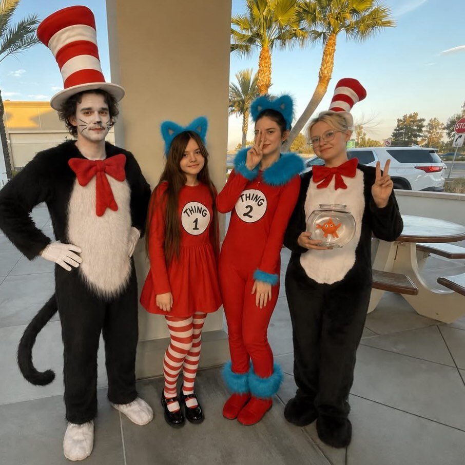 Four people in Cat in the Hat and Thing 1 and 2 costumes posing.