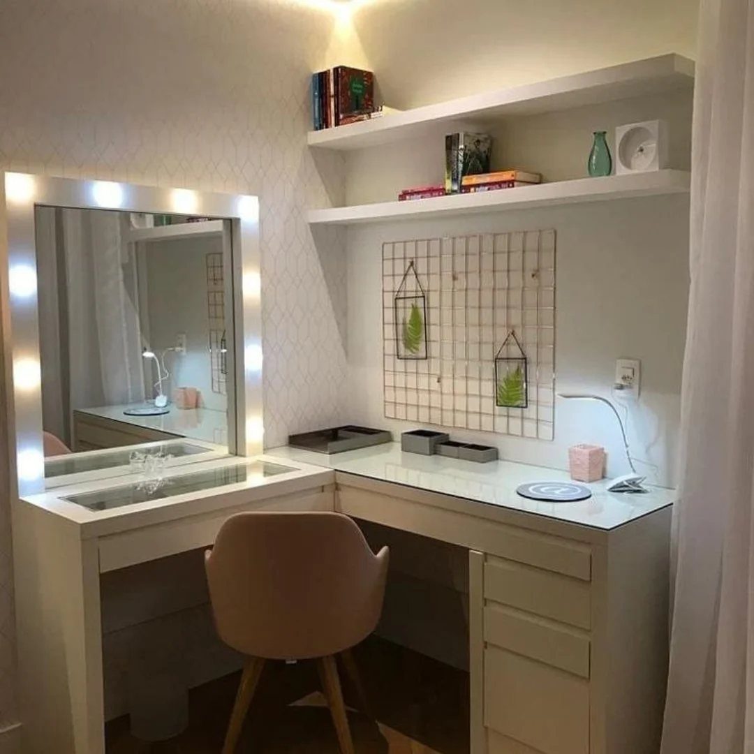 White vanity desk with lighted mirror and beige chair used as a workspace.