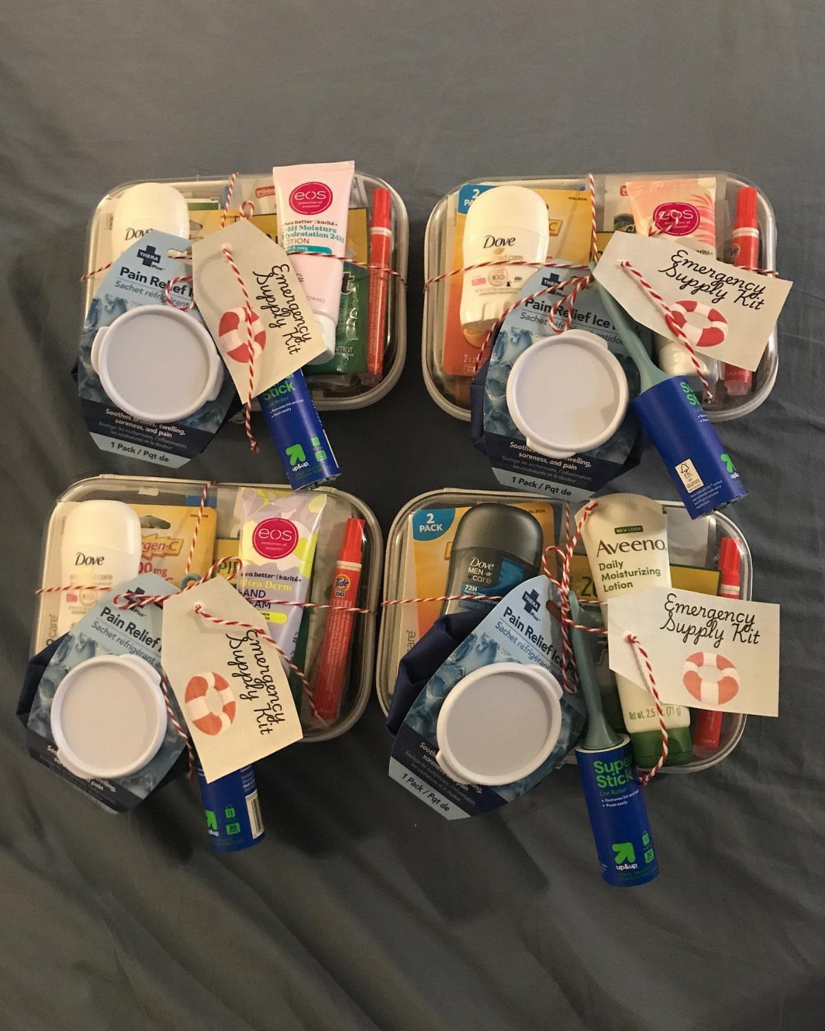 Four metal trays filled with travel-sized toiletries and emergency supply kit tags.