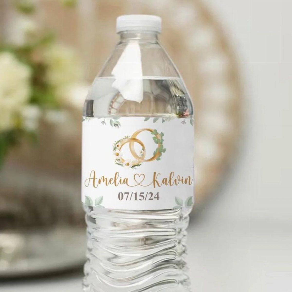 Water bottle with a custom wedding label featuring gold rings and names.