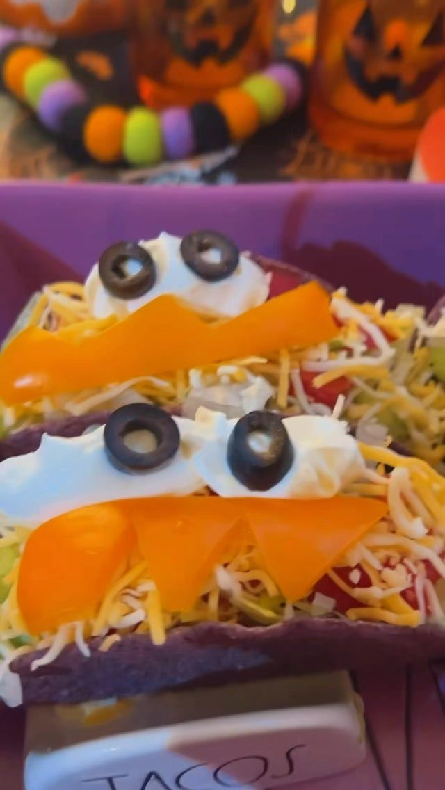 Taco salads with sour cream and olive eyeballs and orange cheese mouths.