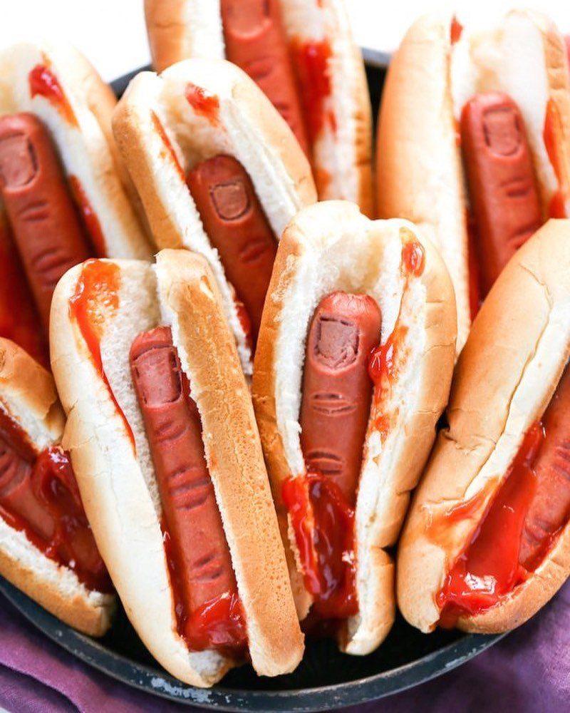 Hot dogs carved to look like severed fingers with ketchup in white buns