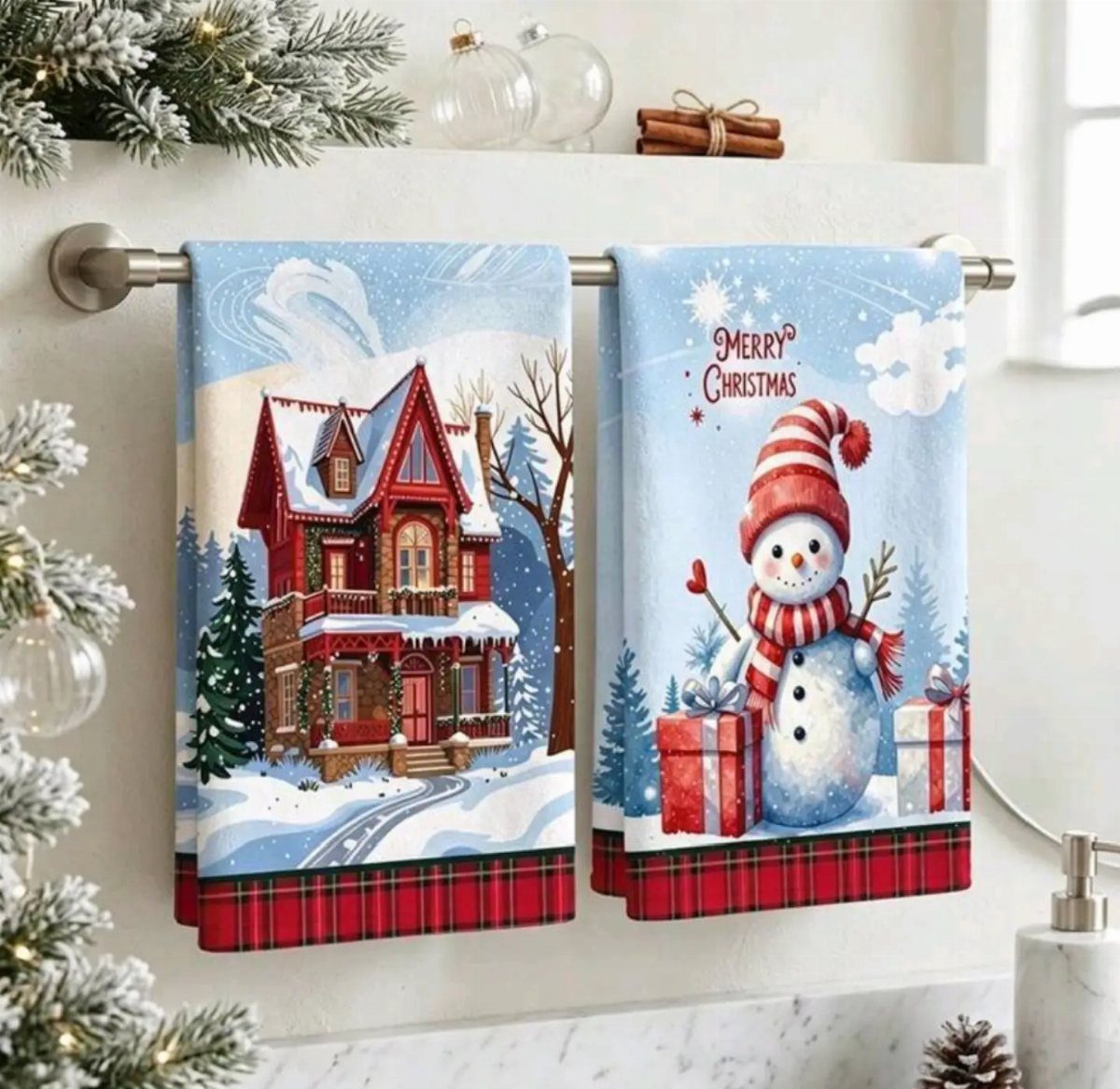 Two Christmas themed dish towels with a snowy house and a snowman.