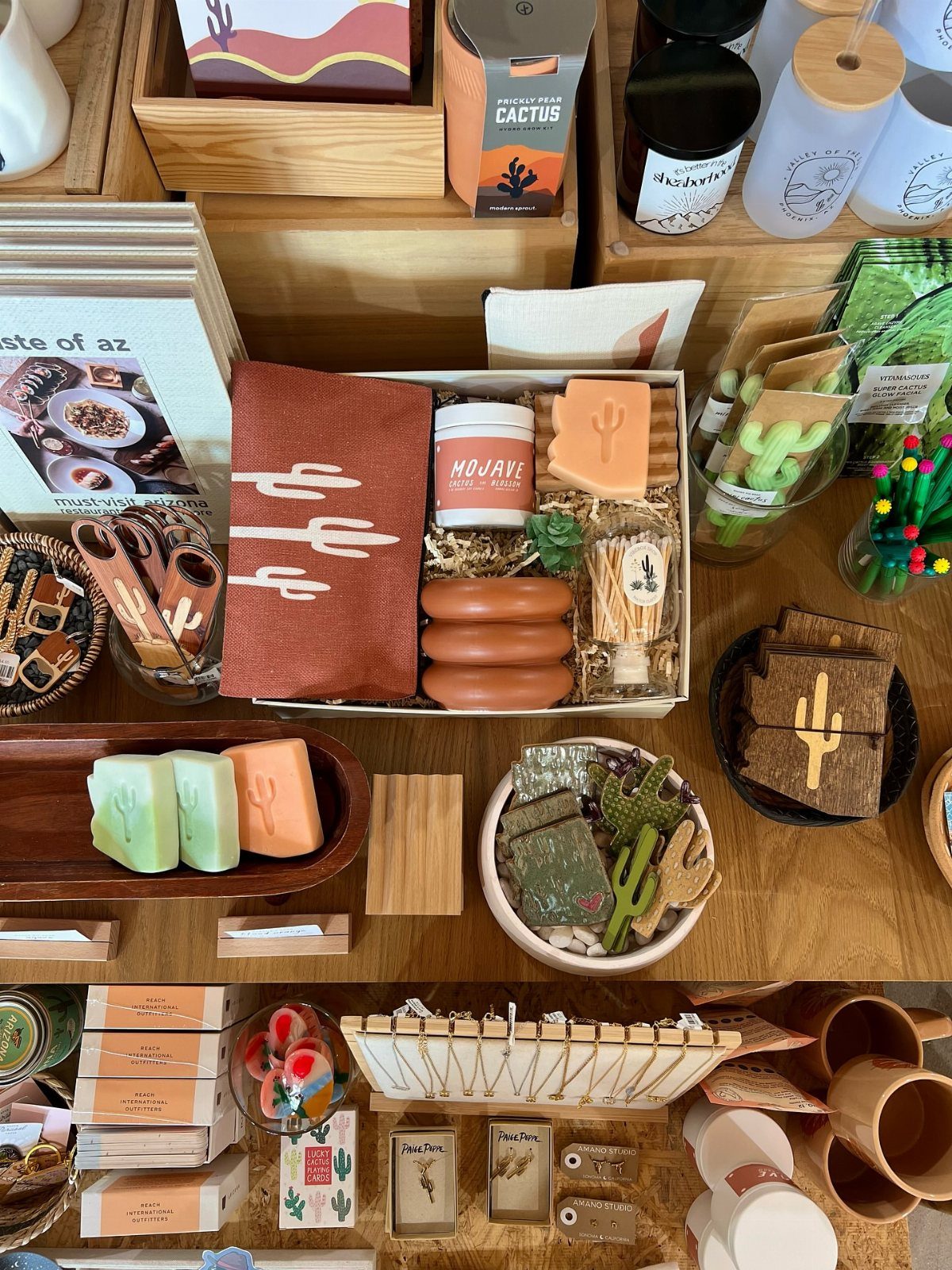 Desert-themed gift basket with terracotta towel, soaps, and skincare on a wooden table.