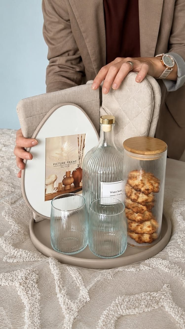 Beige gift tray with cookies in a jar, glassware, and a picture frame.