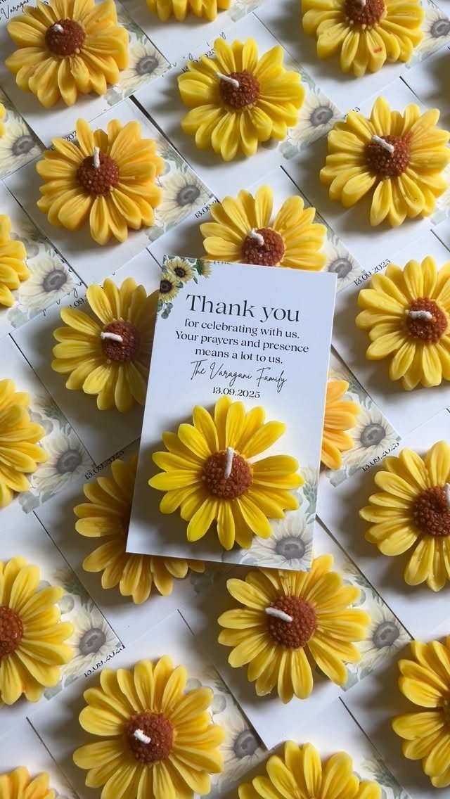 Yellow sunflower candles on thank you cards arranged in a grid pattern.