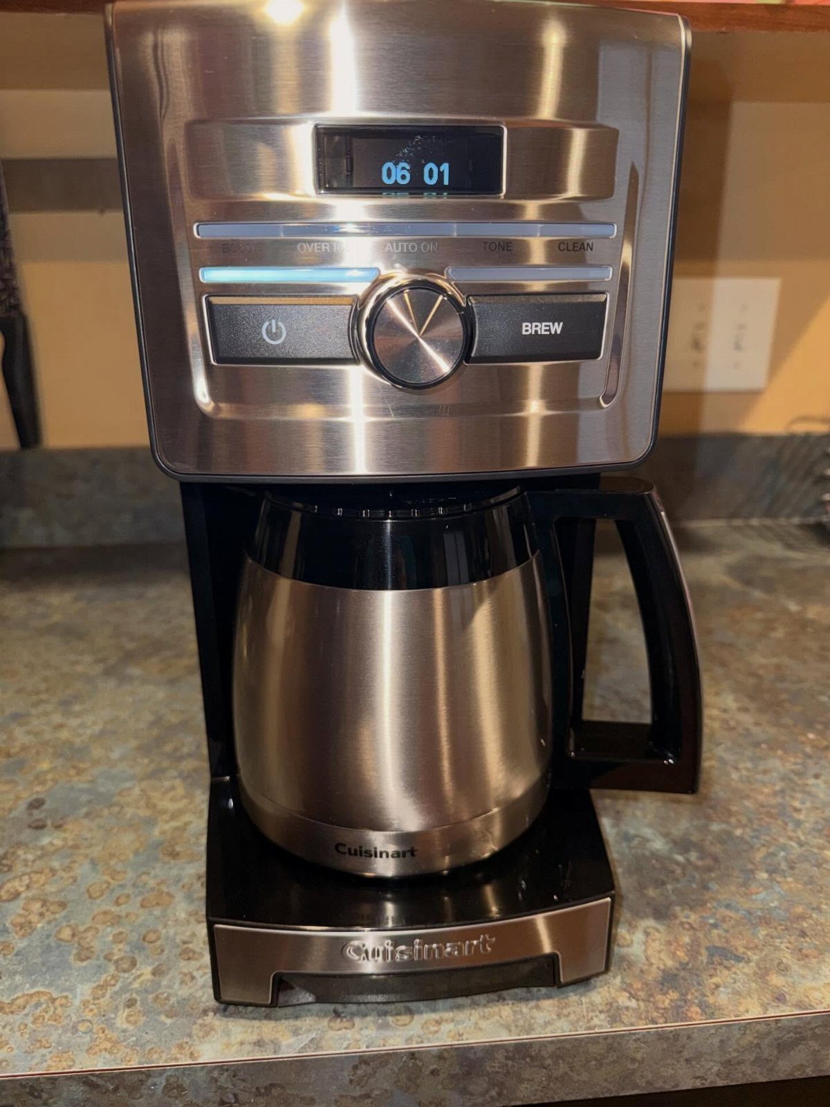 Stainless steel Cuisinart coffee maker with thermal carafe on a granite countertop.
