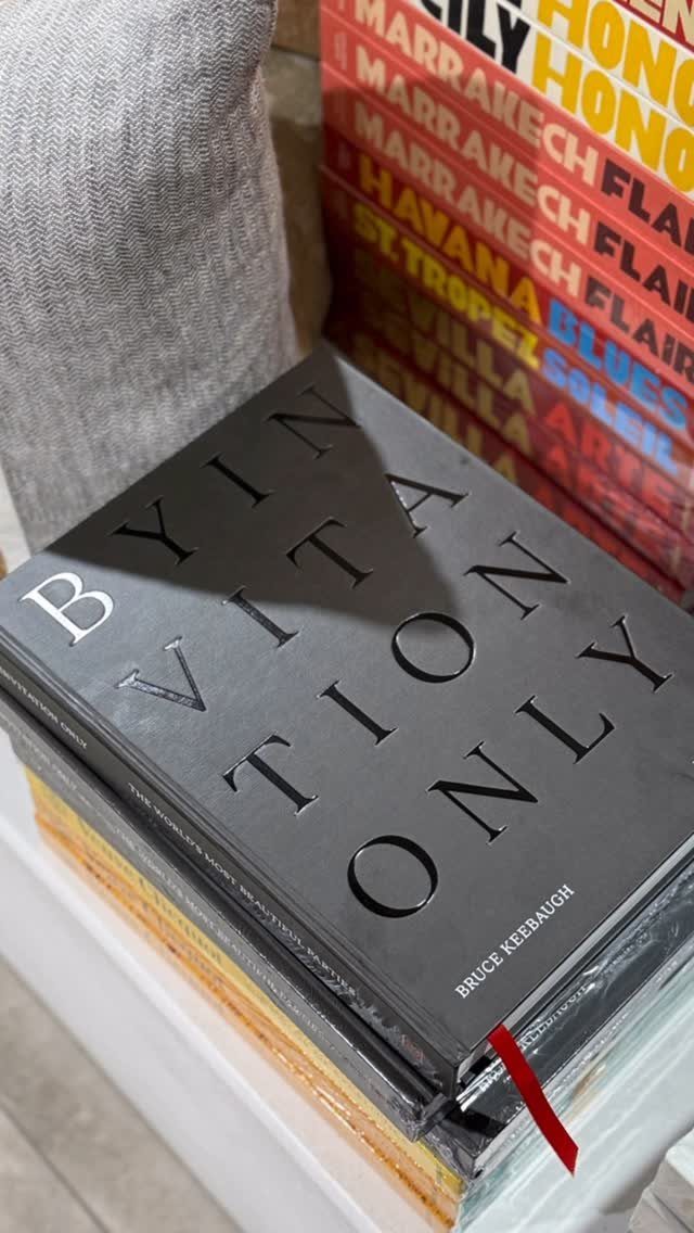 Black hardcover book titled By Virtue Only resting on a white surface.