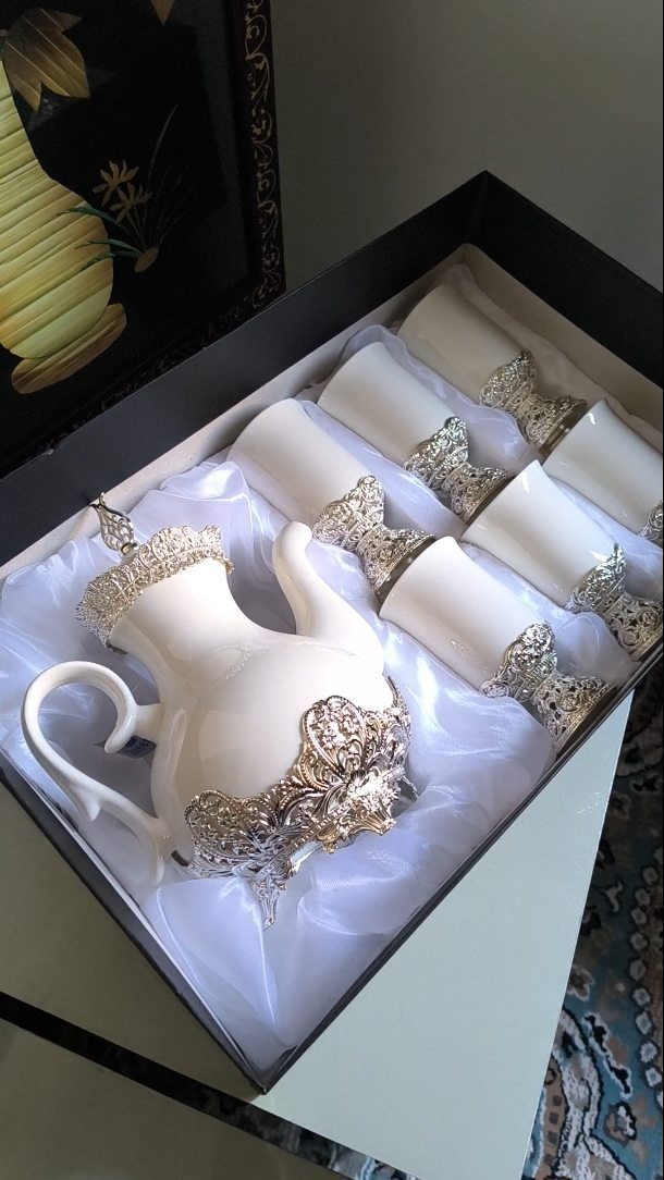 White ceramic tea set with silver accents in a black gift box