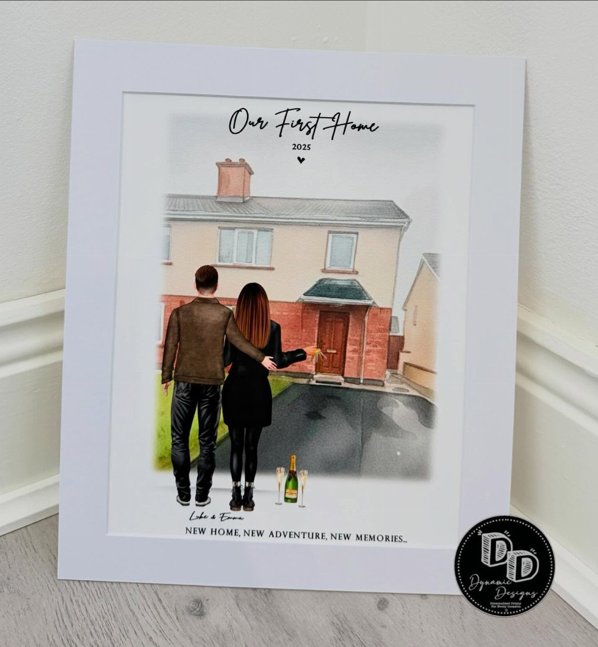 Framed watercolor illustration of a couple standing in front of their first home.