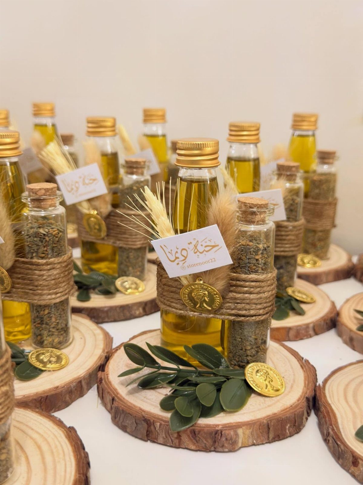 Small bottles of oil and dried herbs on rustic wooden slices with gold coins.