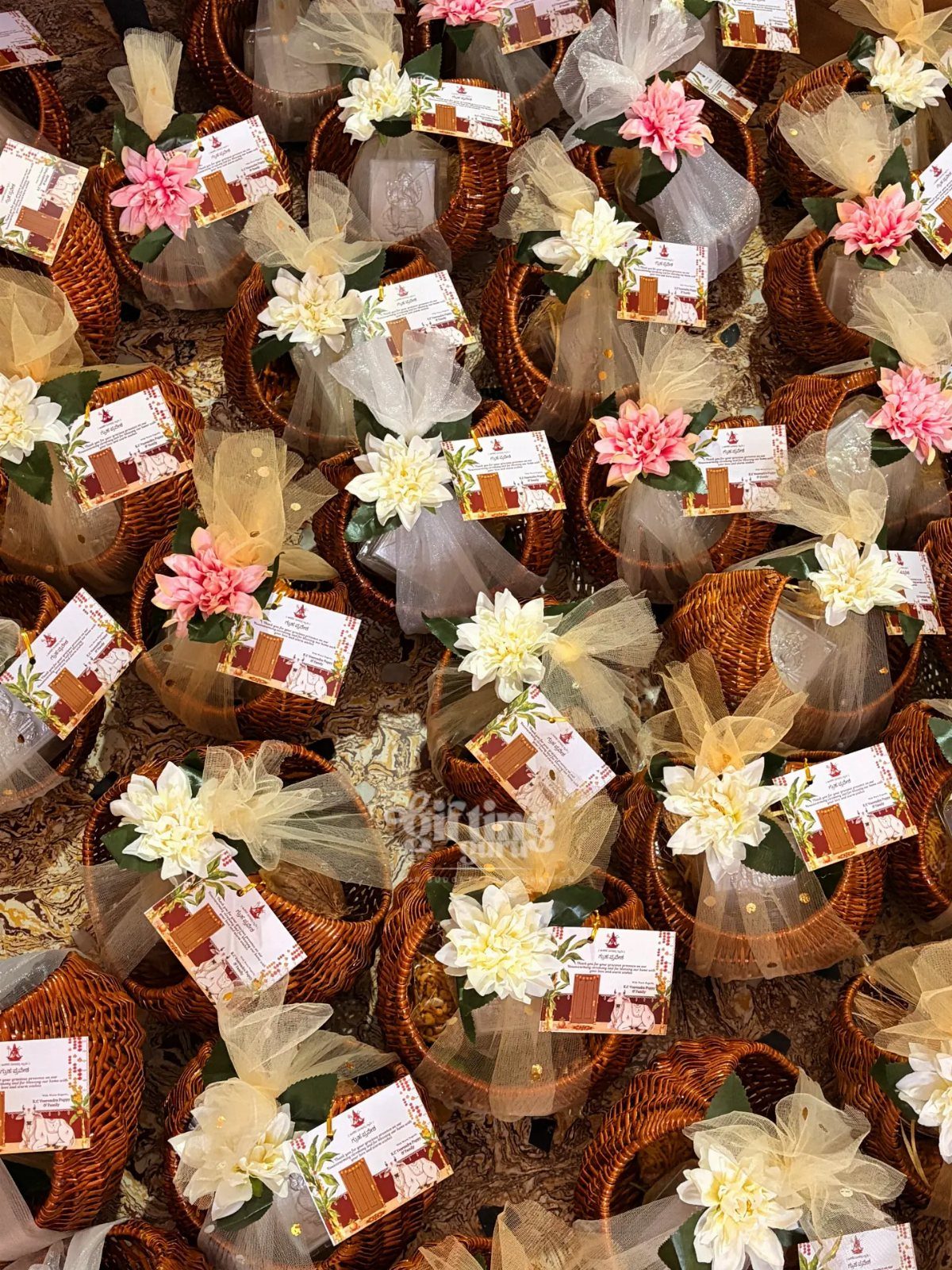 Small wicker baskets with flowers and house tags as housewarming party favors.