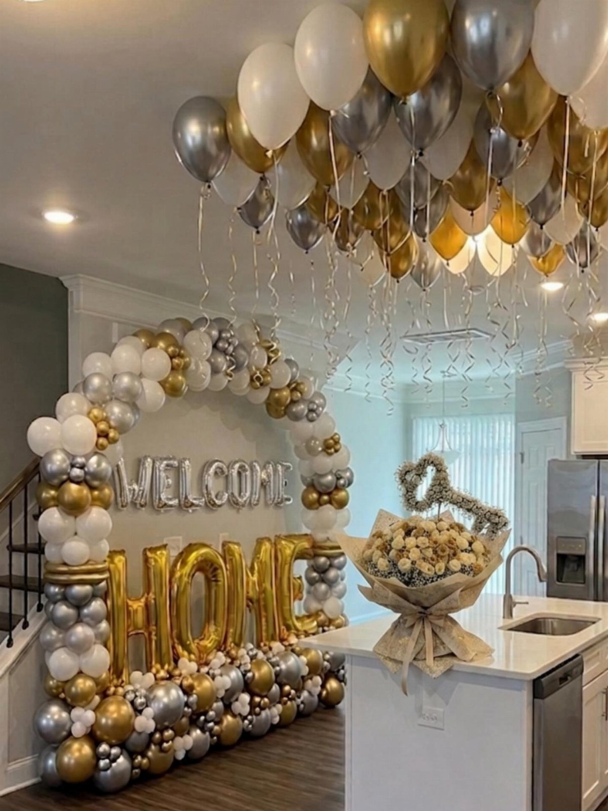 Balloon arch spelling Welcome Home with gold, silver, and white balloons in kitchen