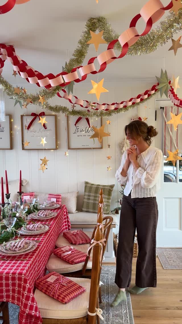 Woman standing by a Christmas party table with red checkered linens and ceiling decorations
