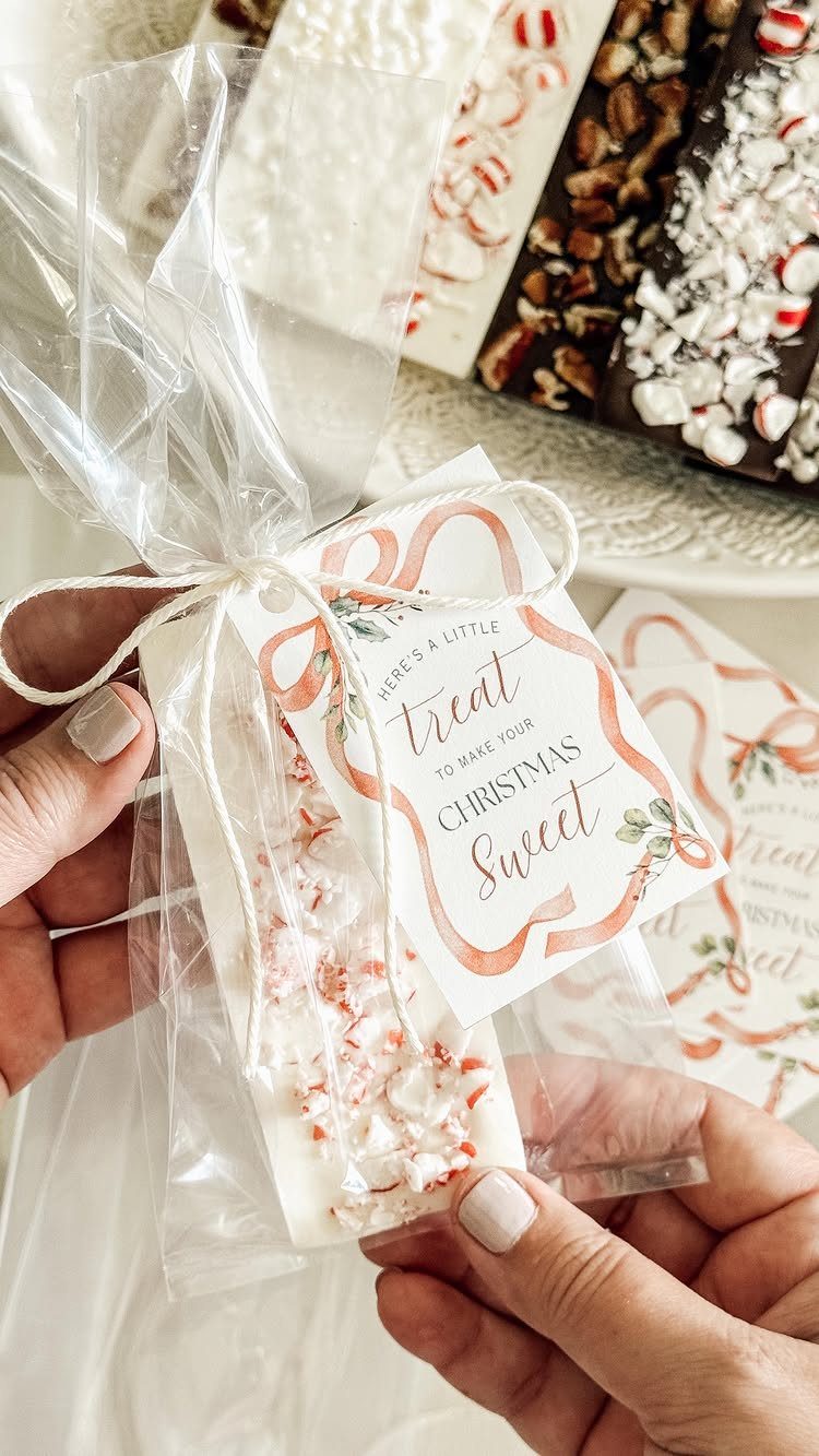 White chocolate peppermint treats in clear gift bags with Christmas themed tags.