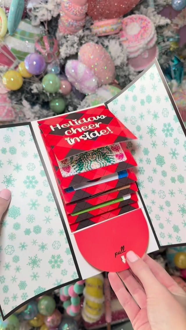 Holiday greeting card with a pull-tab revealing multiple gift cards and vouchers.