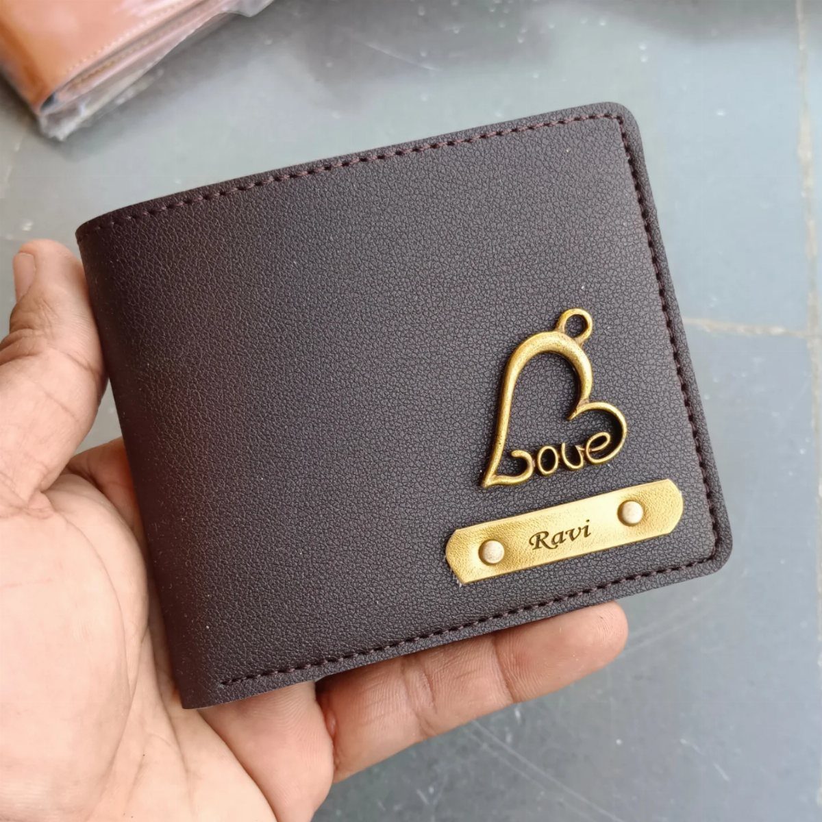 Brown leather wallet with a gold heart charm and engraved name plate Ravi