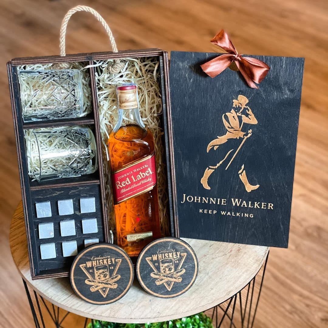 Whiskey gift set with bottle, glasses, and stones in a wooden box.