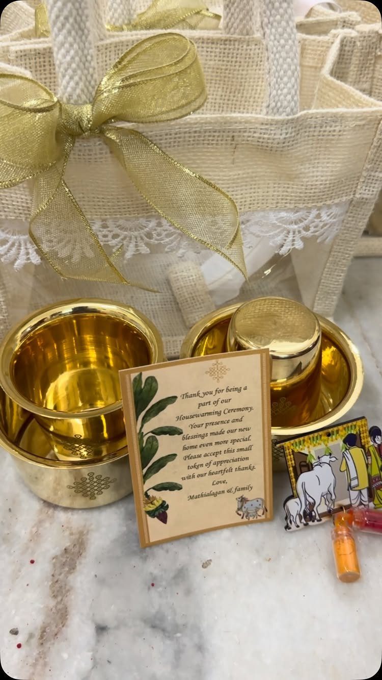 Gold metal bowls and a personalized thank you card next to a gift bag.