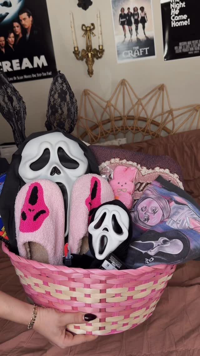 Pink woven gift basket filled with Scream movie themed slippers and Ghostface masks.