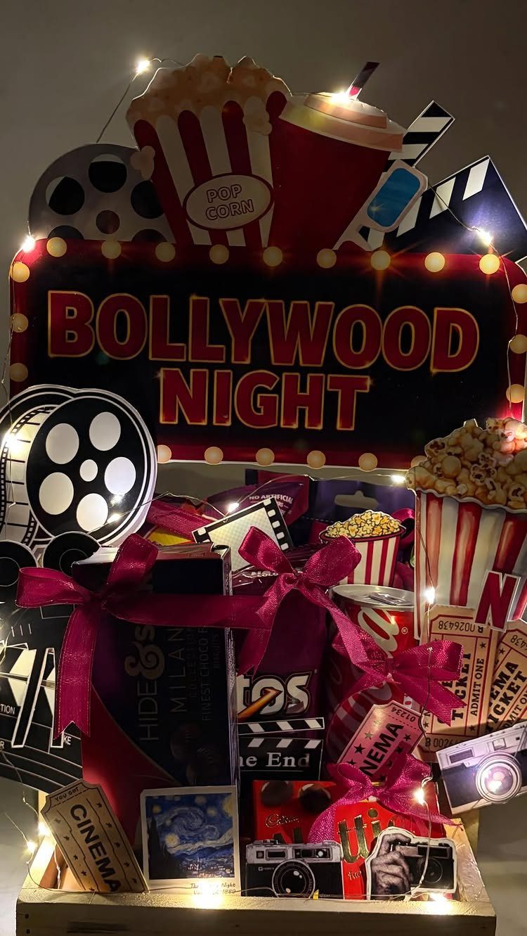 Movie themed gift basket with Bollywood Night sign, popcorn, and film reels.