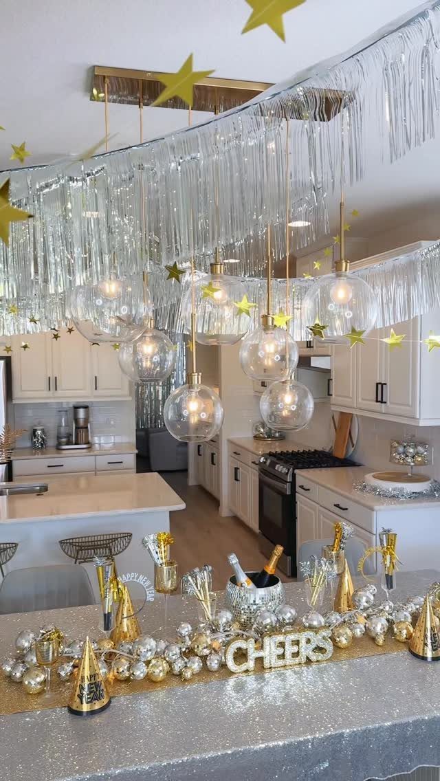 Festive New Year's Eve party decorations in a kitchen with silver tinsel and gold accents.