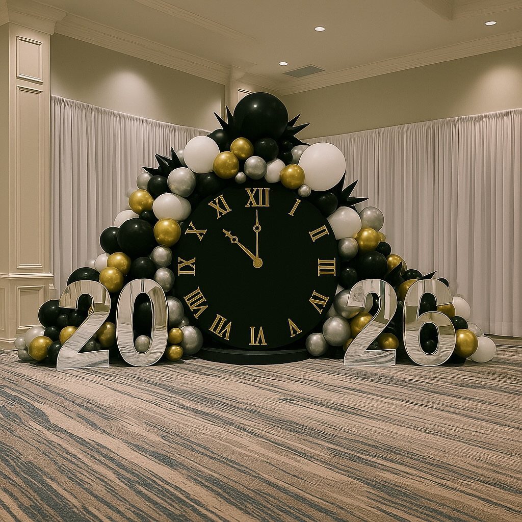 New Year's Eve party decoration with a giant clock, balloons, and 2026 numbers.